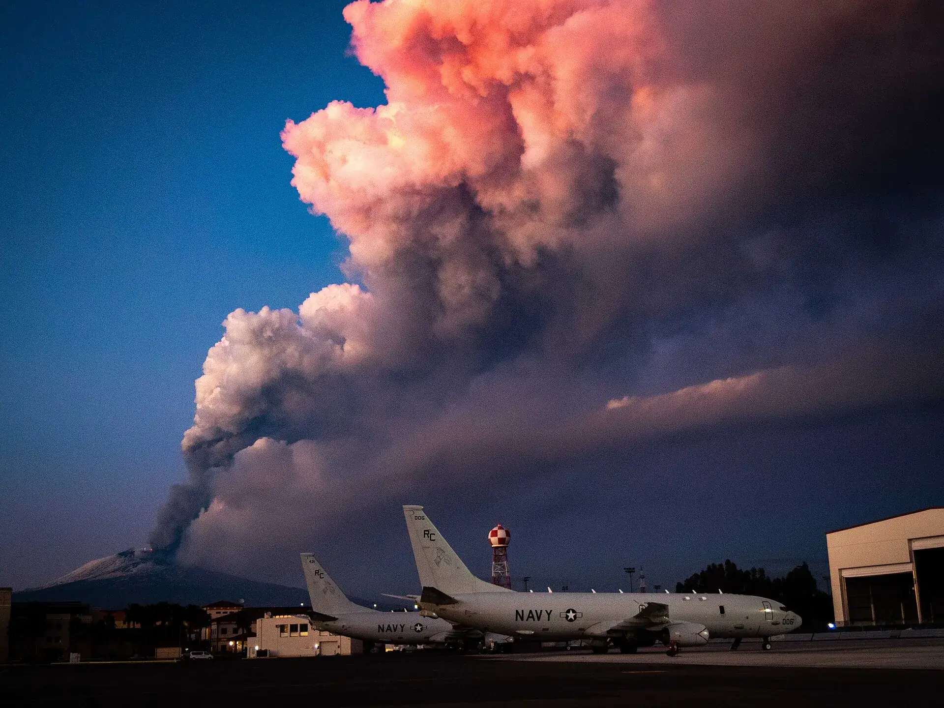 Ash column above Mount Etna on February 16, 2021, with aircraft on the airfield at Sigonella near Catania in the foreground