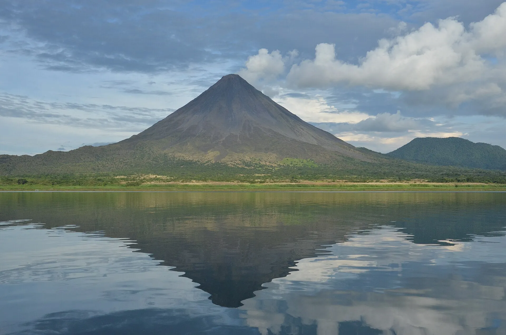 Arenal Volcano reflected in the still water of Lake Arenal