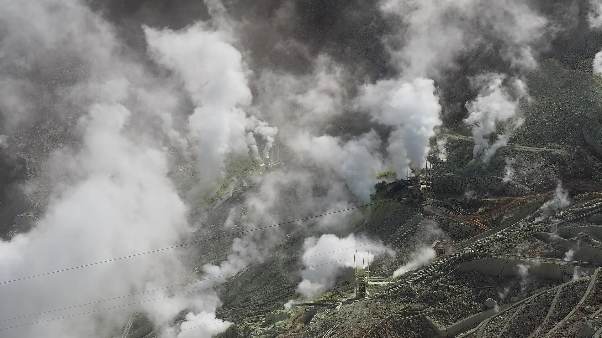 Dense white clouds of steam rising from the fumarole field of Ōwakudani in Hakone