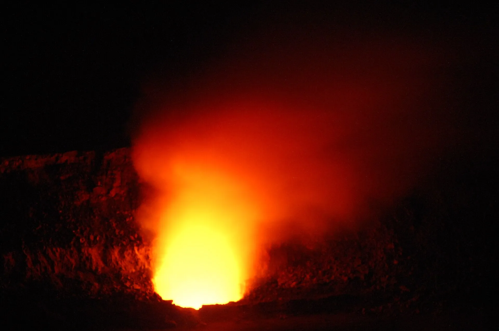 Red glow from lava inside Halemaʻumaʻu crater at night, Hawaiʻi Volcanoes National Park (photo from 2008)