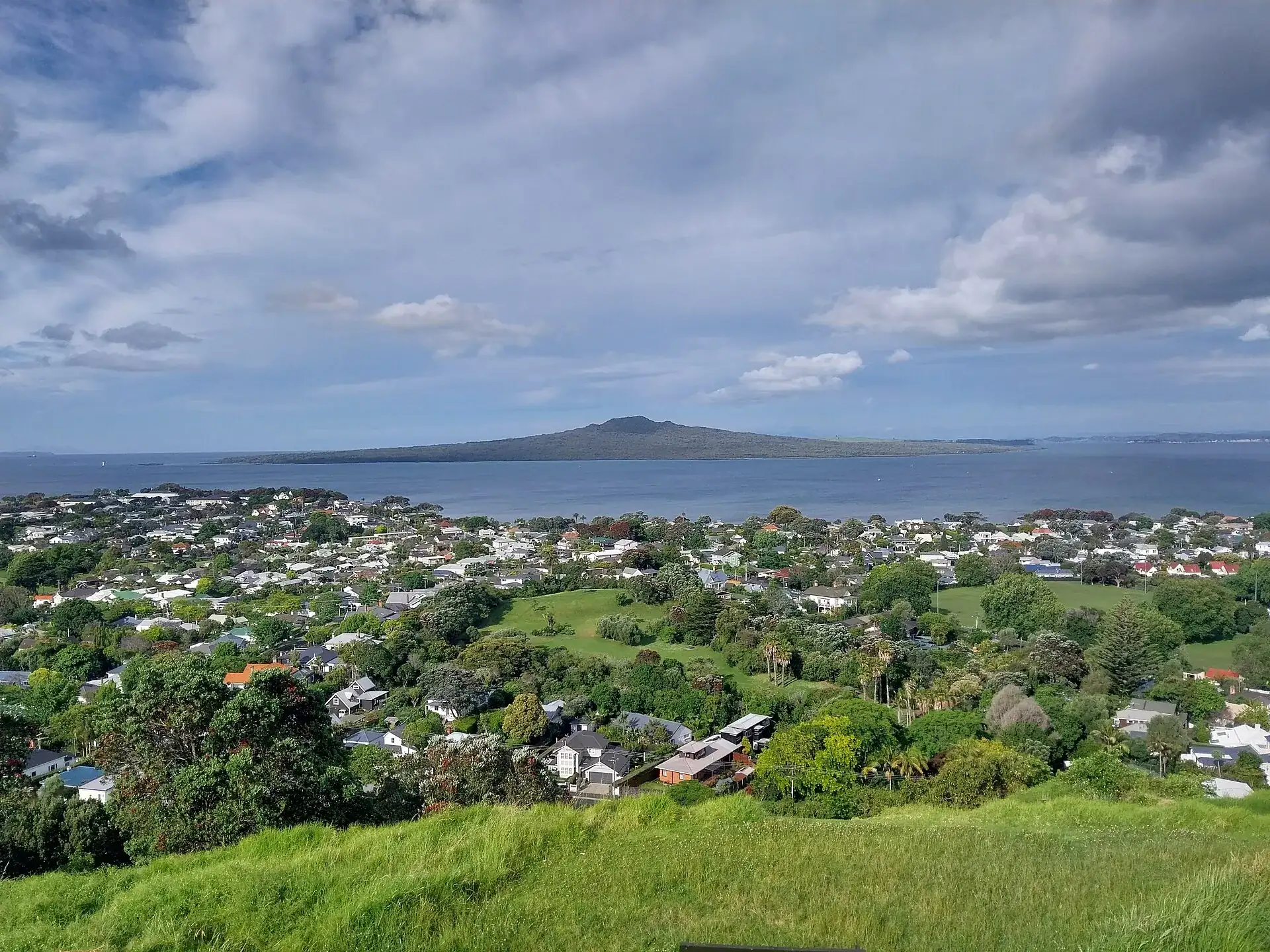 Rangitoto Island seen from Mount Victoria in Devonport: the low volcanic cone lies beyond the Hauraki Gulf, with the houses of Auckland in the foreground