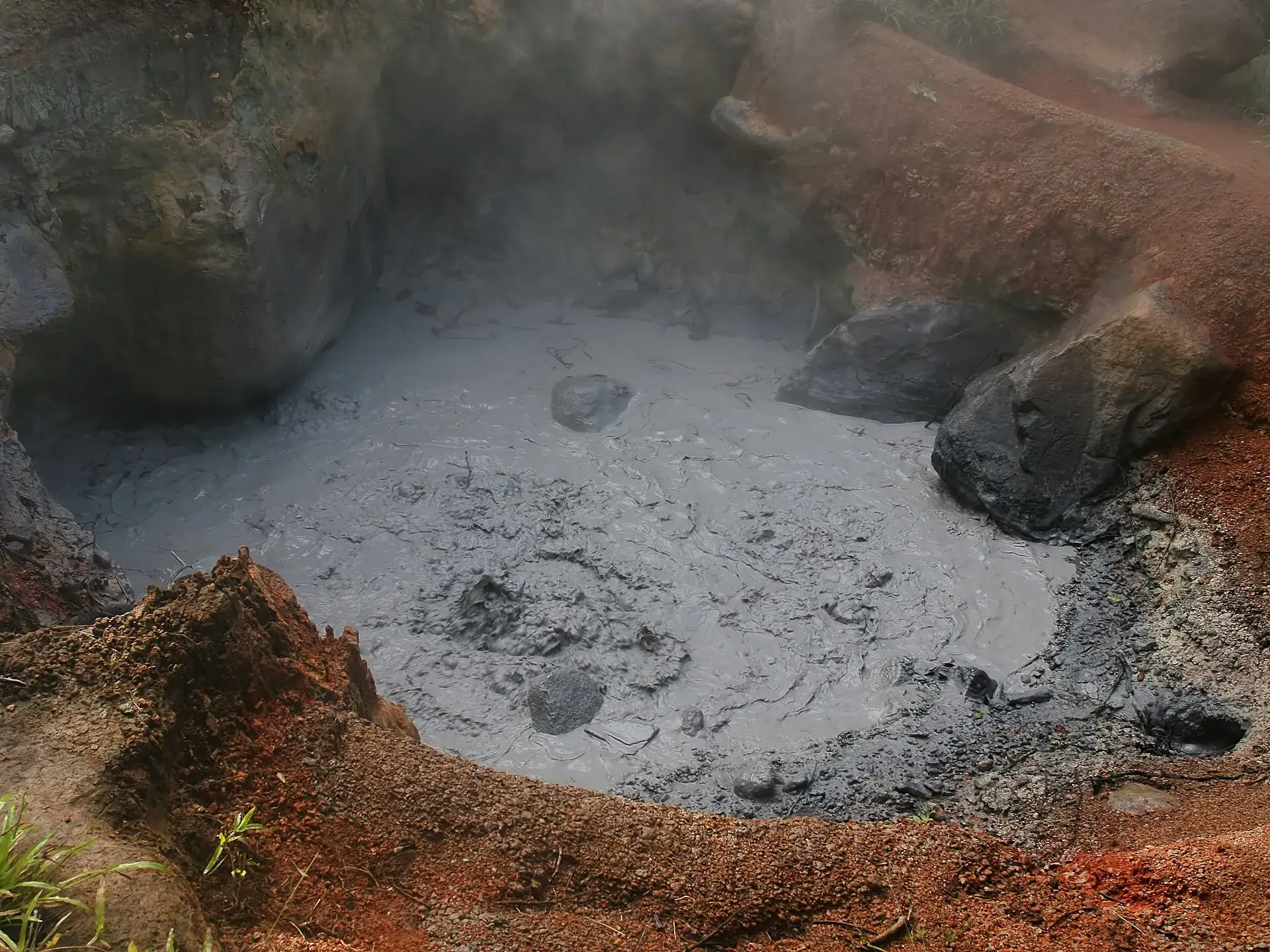 The Volcancito in Rincón de la Vieja National Park: a steaming hollow of gray mud, surrounded by reddish-brown rock