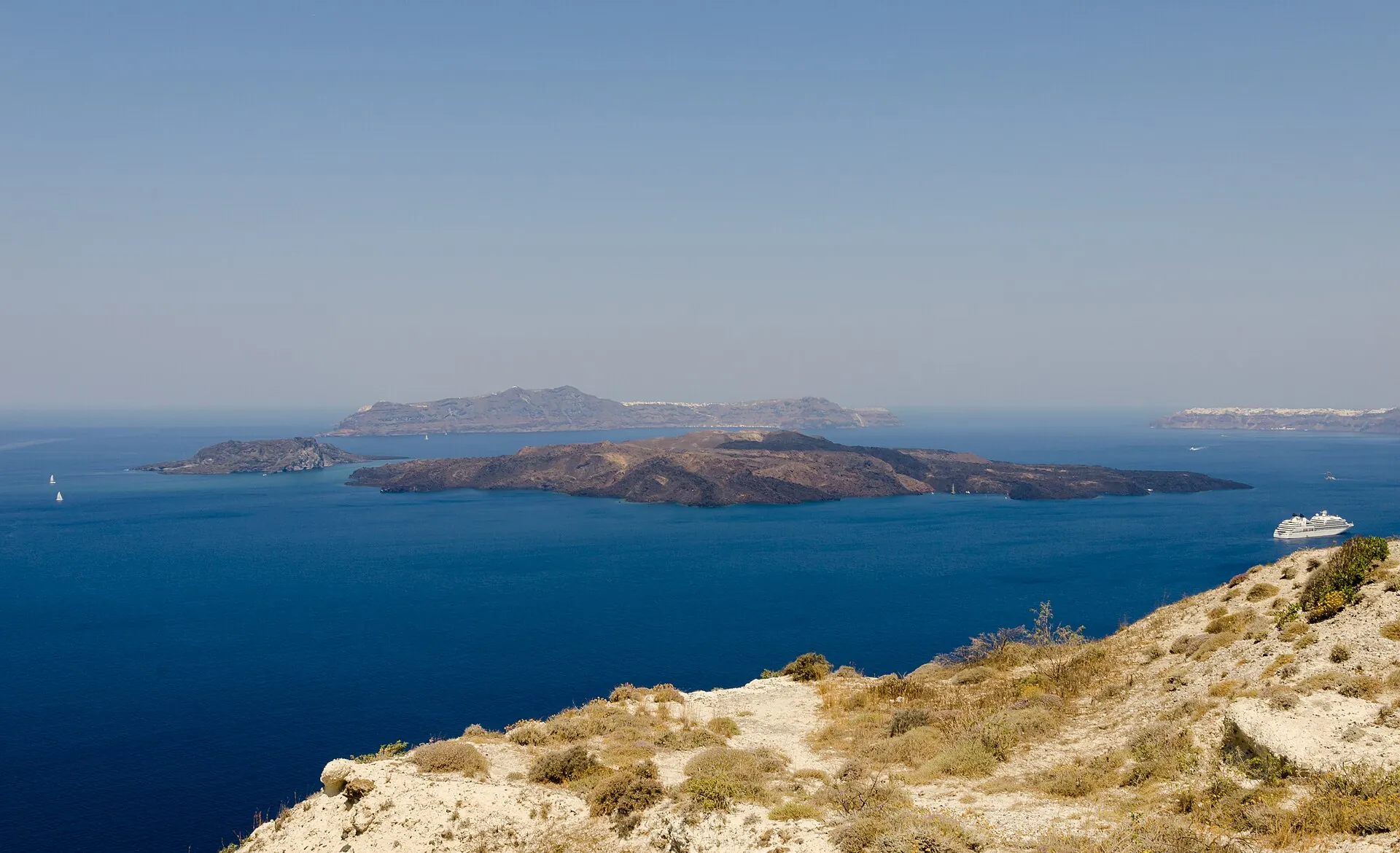 Die Lavainseln Nea Kameni und Palea Kameni in der Caldera, dahinter Thirasia