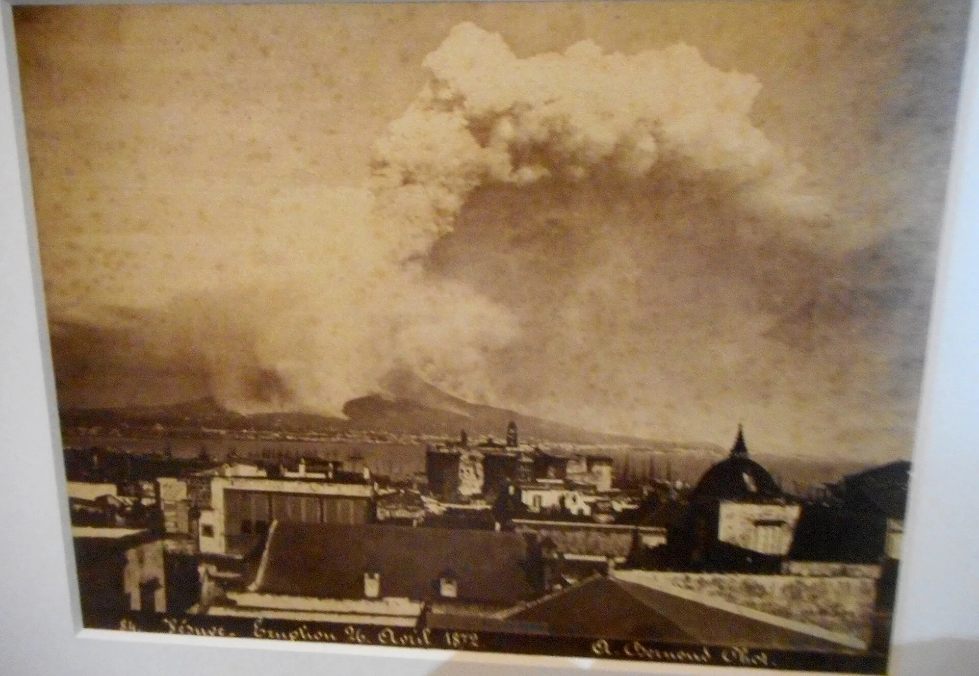 Historical photograph by Alphonse Bernoud: the ash column of Vesuvius above the rooftops of Naples on April 26, 1872