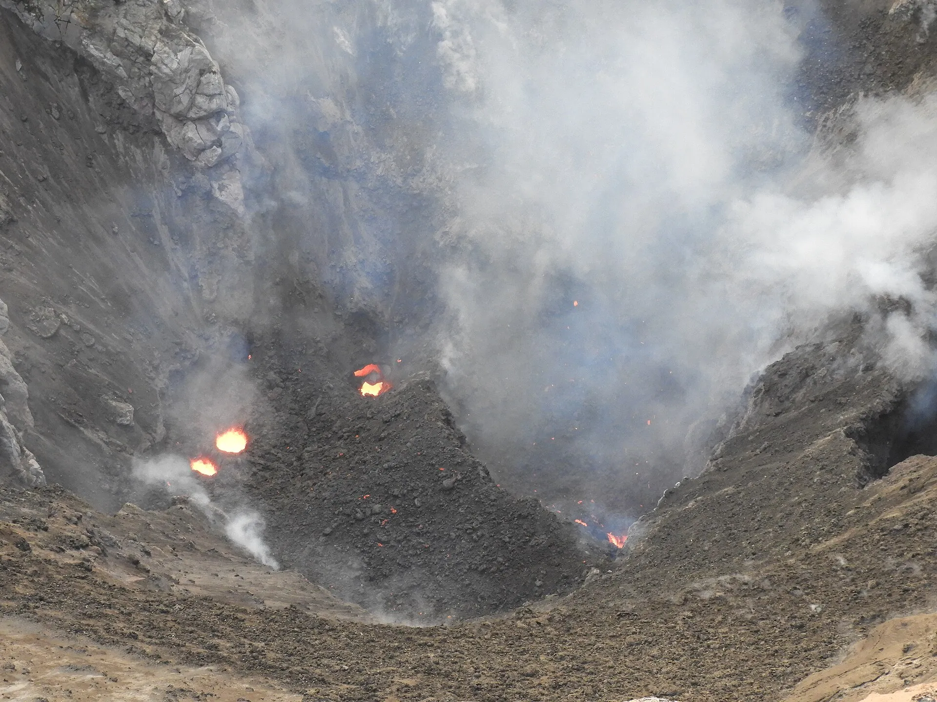 Blick in den rund 400 Meter weiten Krater des Mount Yasur mit mehreren dampfenden Schloten am Grund